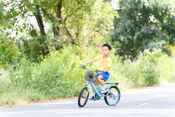 Boy riding bicycle on the road.