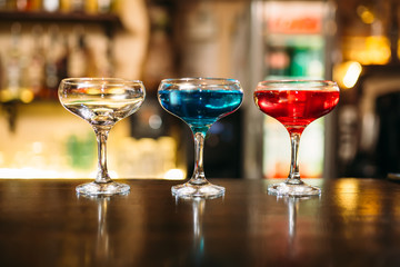 Cocktails on wooden bar counter closeup
