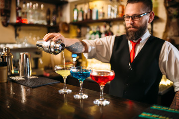 Barman making alcohol cocktails in nightclub