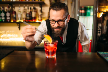 Bartender making alcohol coctail in restaurant