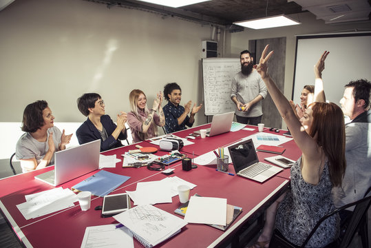 Colleagues celebrating good news during a meeting