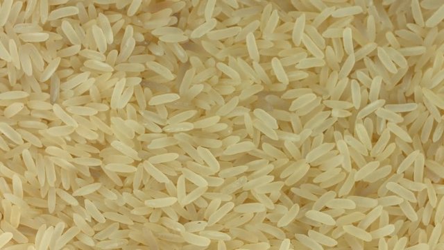 Rice background, closeup raw rice rotation. 4K video footage. Ultra HD 3840X2160