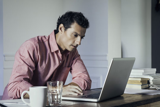 Man working on laptop computer at home
