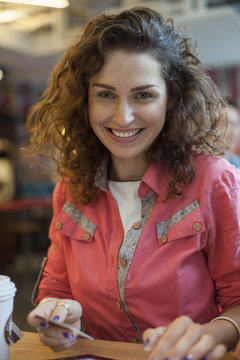 Woman paying with a credit card, portrait