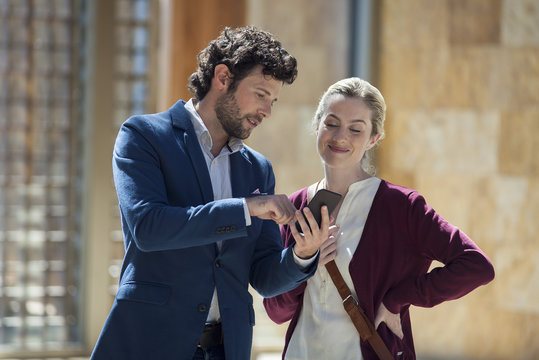 Couple looking at multimedia smartphone