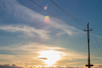 Close up of high voltage power lines on sunset background.