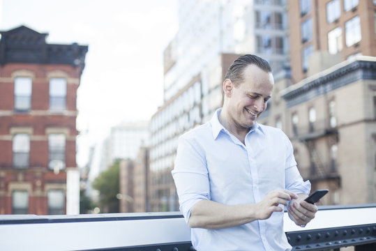 Man text messaging with smartphone