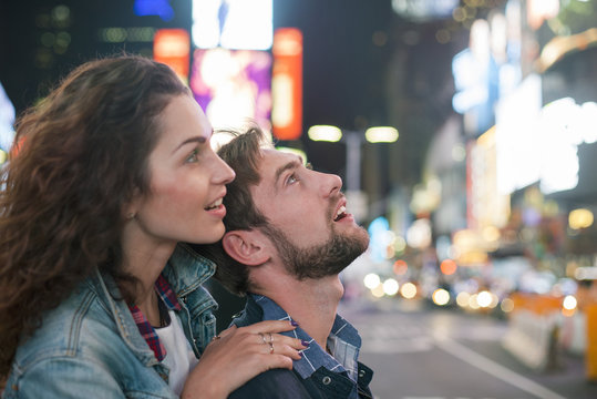 Young couple sightseeing in Times Square, New York City, New York, USA