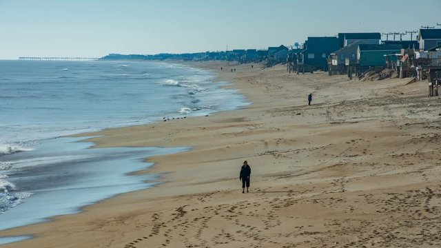 Beach at Kitty Hawk North Carolina with People Walking Along the Sand between the Atlantic and Oceanfront Homes