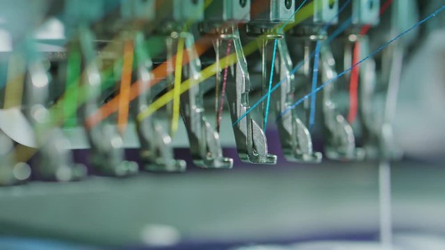 Embroidery machine starting to embroider with a needle on the fabric