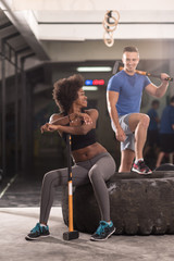 multiethnic couple after workout with hammer