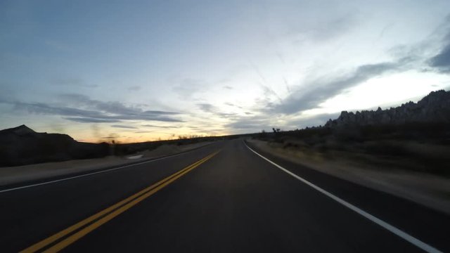 Desert twilight driving time lapse on Kelbaker Road through the Mojave National Preserve in Southern California.  