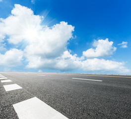 asphalt road under the blue sky