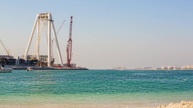 dubai marina beach sunny day wheel stand construction panorama 4k time lapse uae
