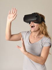 attractive blond woman wearing headset VR virtual reality vision goggles watching video