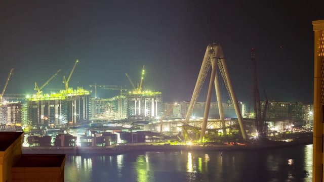 night light dubai marina hotel wheel construction rooftop panorama 4k time lapse uae
