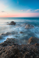 Waves and rocks shore long exposure