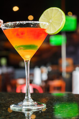 I count on some cocktails in a bar on a marble table on a black restaurant background.