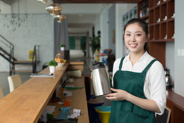 young pretty woman works in cafe
