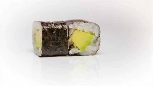 Avokado maki vegetarian roll. Traditional Japanese food - sushi rolls on white background.