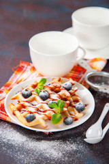 Homemade wafers with berries and tea on a table. Selective focus. Copy space.