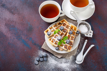 Homemade wafers with berries and tea on a table. Selective focus. Copy space.