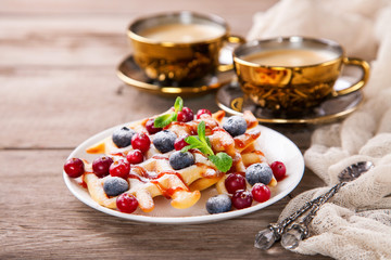 Homemade wafers with berries and coffee on a table. Selective focus. Copy space.