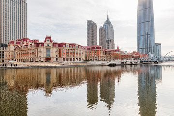 Fototapeta na wymiar River And Modern Buildings Against Sky in Tianjin,China.
