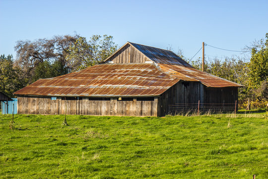 Old Leaning Wood Barn With Rusted Tin Roof