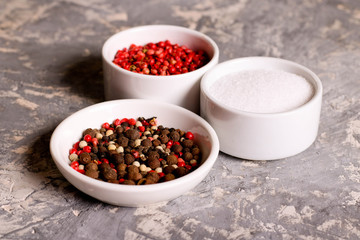assortment of pepper and salt in bowls, closeup, horizontal