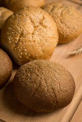 Tasty fresh buns on the wooden background