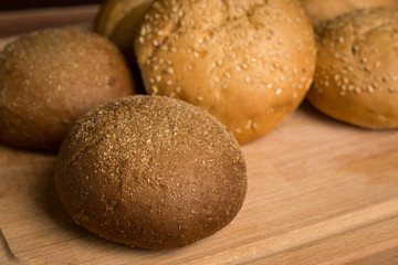 Tasty fresh buns on the wooden background