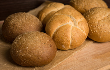 Tasty fresh buns on the wooden background