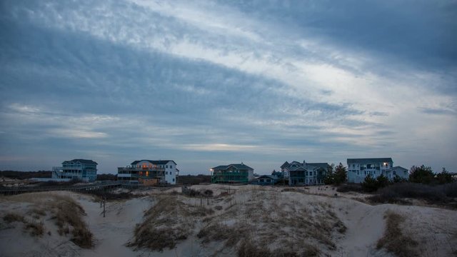 Outer Banks Real Estate on the Sand Dunes of Carolla Beach NC at Dusk Timelapse with Fast Moving Clouds
