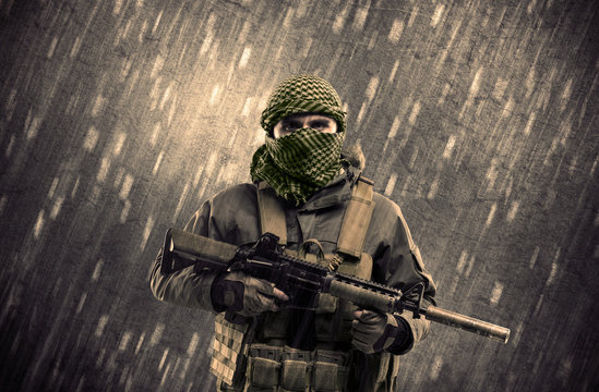 Armed terrorist man with mask on rainy background
