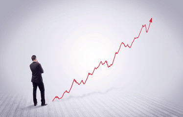 Standing businessman with red graph arrow