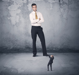 Obraz premium Big business bully looking at small coworker