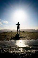 Silhouette of Man Taking Pictures During Beach Sunset