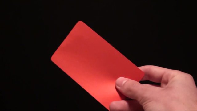 Football referee showing a red card to a player on black background. cards penalty. Adrian