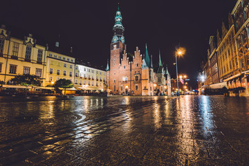 Wroclaw, Silesia, Poland - September, 19th, 2016. Market Square by night illumination. Wroclaw Town Hall, built in Gothic architecture style, one of the main landmarks and attractions in city.