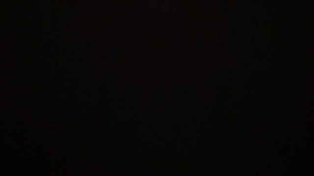 Football referee showing a yellow card to a player on black background. Cards penalty, punishment. Adrian