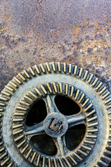 old large gearwheel on rusty metal background