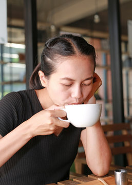 Woman drinking hot coffee in the morning.