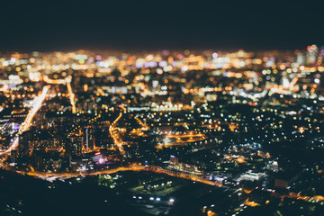 True tilt shift shooting of highway in residential district during night in metropolis from high...