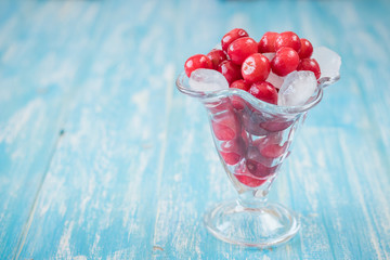 Frozen berries cherry on vintage wooden table.
