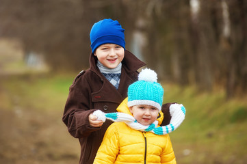 Children on a spring walk .Brother and sister having fun .