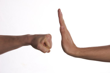 One hand preventing punch attack of another hand on isolate white background.