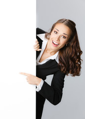 Businesswoman showing signboard, over grey