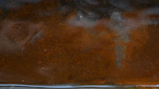 Rusty sheet of metal in the water.