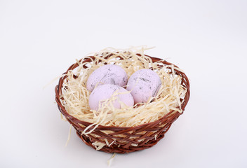 wicker basket with eggs on which different emotions are drawn. Picture for Easter